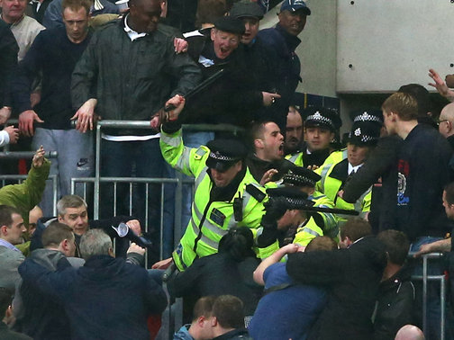 Police try to stop brawling Millwall fans at Wembley 